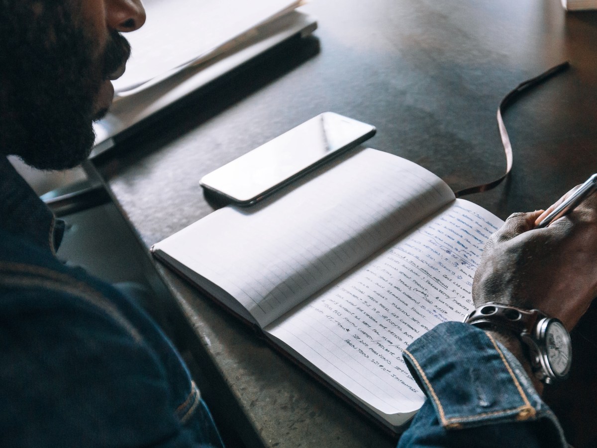 Man writing in a notebook