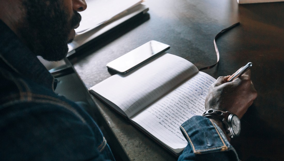 Man writing in a notebook