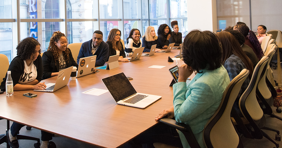 Conference room table filled with a diverse group of people